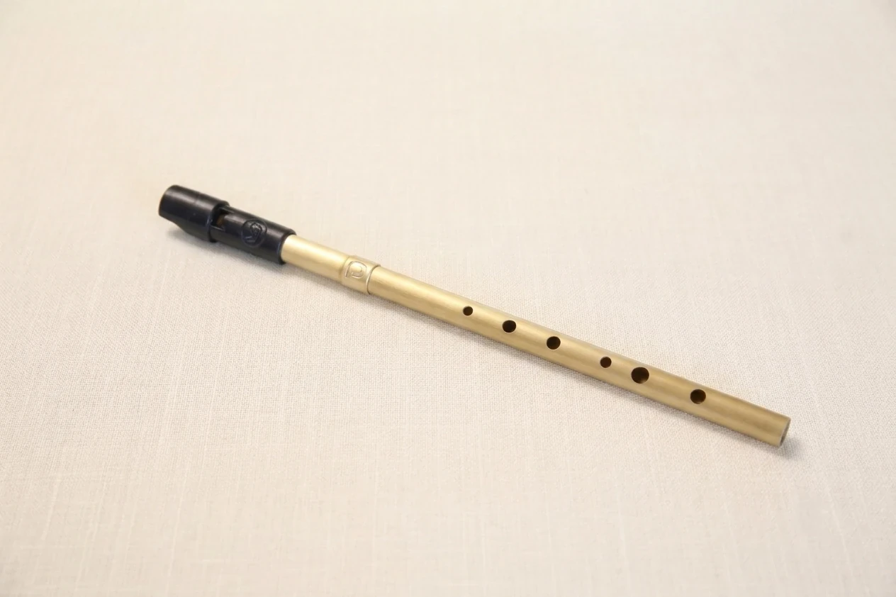 Handcrafted whistle resting on linen